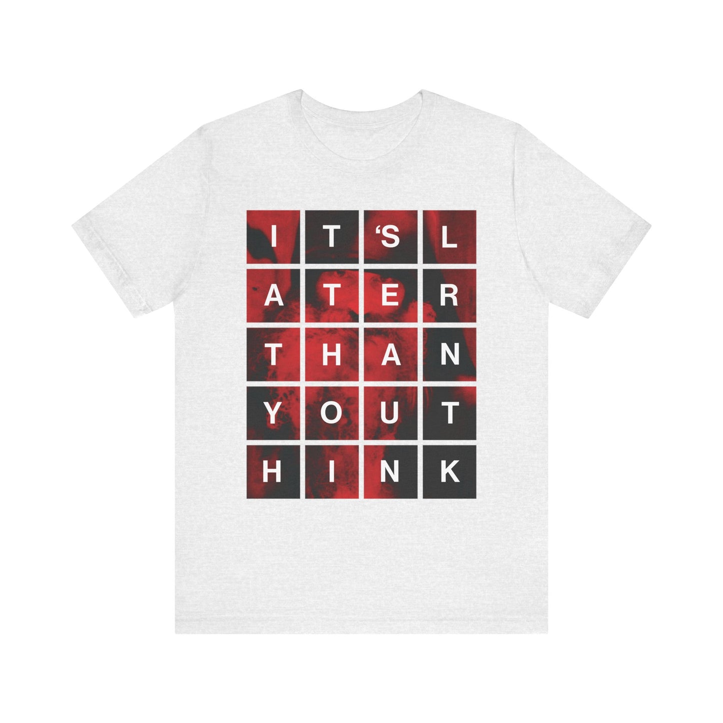 Ash Tee featuring a modern block design with bold black grid text: ITS LATER THAN YOU THINK over a red and black abstract background—a striking Orthodox Christian reminder inspired by St. Seraphim Rose to reflect on repentance and the coming of the Kingdom of God. Lightweight cotton unisex fit.
