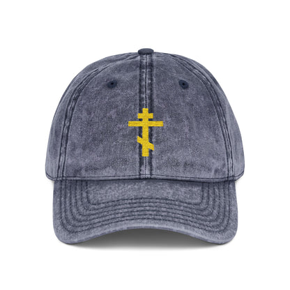 Navy distressed cap featuring a simple yellow Orthodox TriBar cross embroidered on the front—minimalist Christian style that symbolizes faith and salvation.