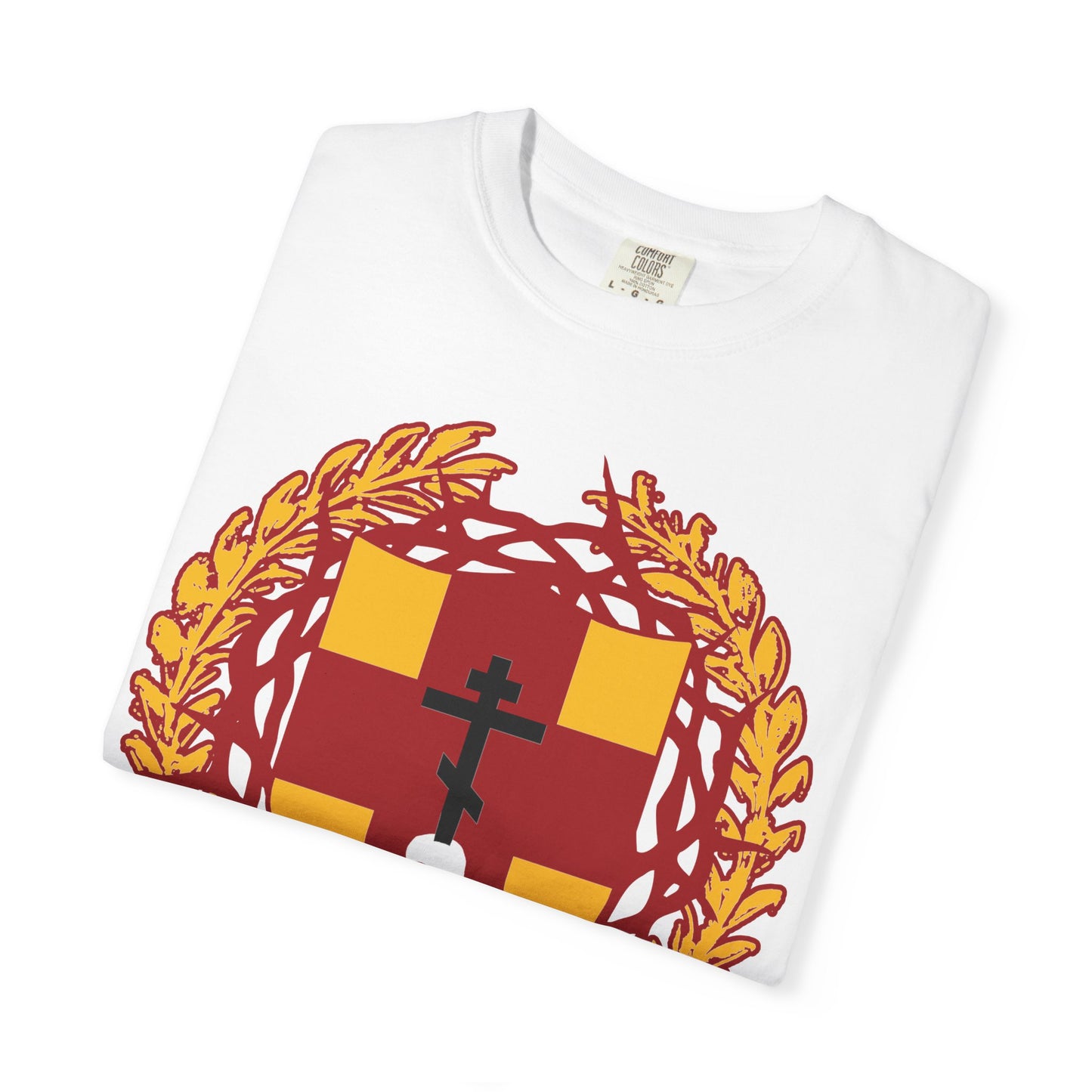 A folded white heavyweight cotton unisex t-shirt featuring a heraldic shield with an Orthodox cross stabbing a skull and a crown of thorns design on the front, inspired by “First-Born from the Dead (Col 1:18)” and the theme of redemption through His blood.