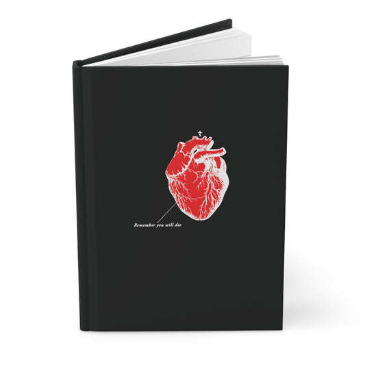 This black hardcover journal features a red anatomical heart illustration with a small cross and Remember You Will Die text in white. It contains lined pages ideal for thoughts or quotes, under the product name: Remember You Will Die | Retro Medical Textbook Heart Design | Orthodox Christian Journal.