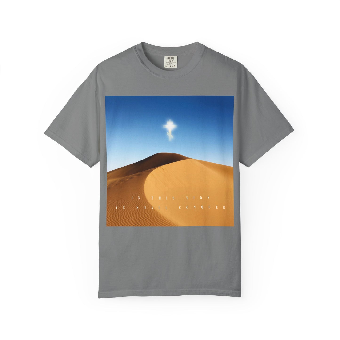 Grey heavyweight cotton unisex tee featuring a desert sun scene and sky print with a glowing cross symbolizing the Elevation of the Cross, accompanied by the text "IN THIS SIGN YE SHALL CONQUER.