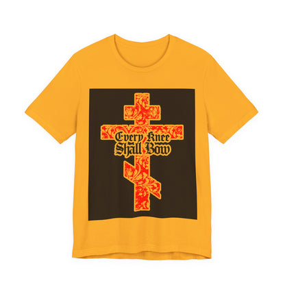 The "Every Knee Shall Bow" Christian unisex tee features a gold and red floral texture Orthodox cross with gothic lettering, inspired by Isaiah 45:22-24 and Philippians 2:7-11.