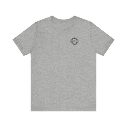 Athletic Heather short-sleeve tee with a small branded logo on the front, inspired by Christian Goth themes of the Ladder of Divine Ascent and quiet renunciation, featuring flower cross & skull graphic.
