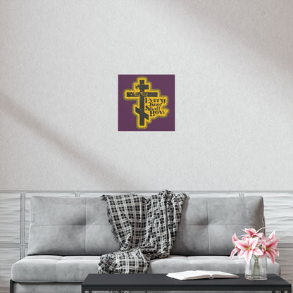 A modern living room features the "Every Knee Shall Bow" Orthodox Christian art poster with a 70s distressed halftone comic book style, inspired by Philippians 2:10-11 and Isaiah 45:23, above a gray sofa with flowers and a checkered throw.