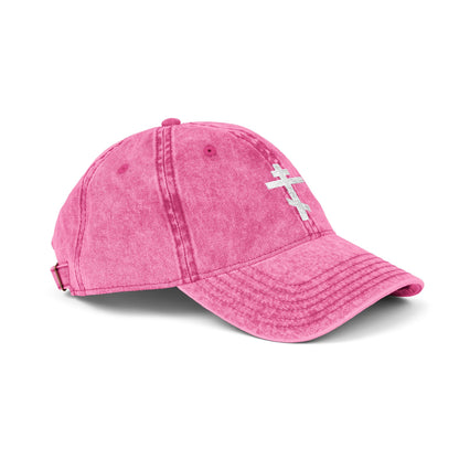 A minimalist pink cap featuring a white Orthodox tri-bar cross, symbolizing Christ’s sacrifice. "Crucify My Ego to the Precious and Life Giving Cross" embroidered in a simple, distressed style for Christian inspiration.