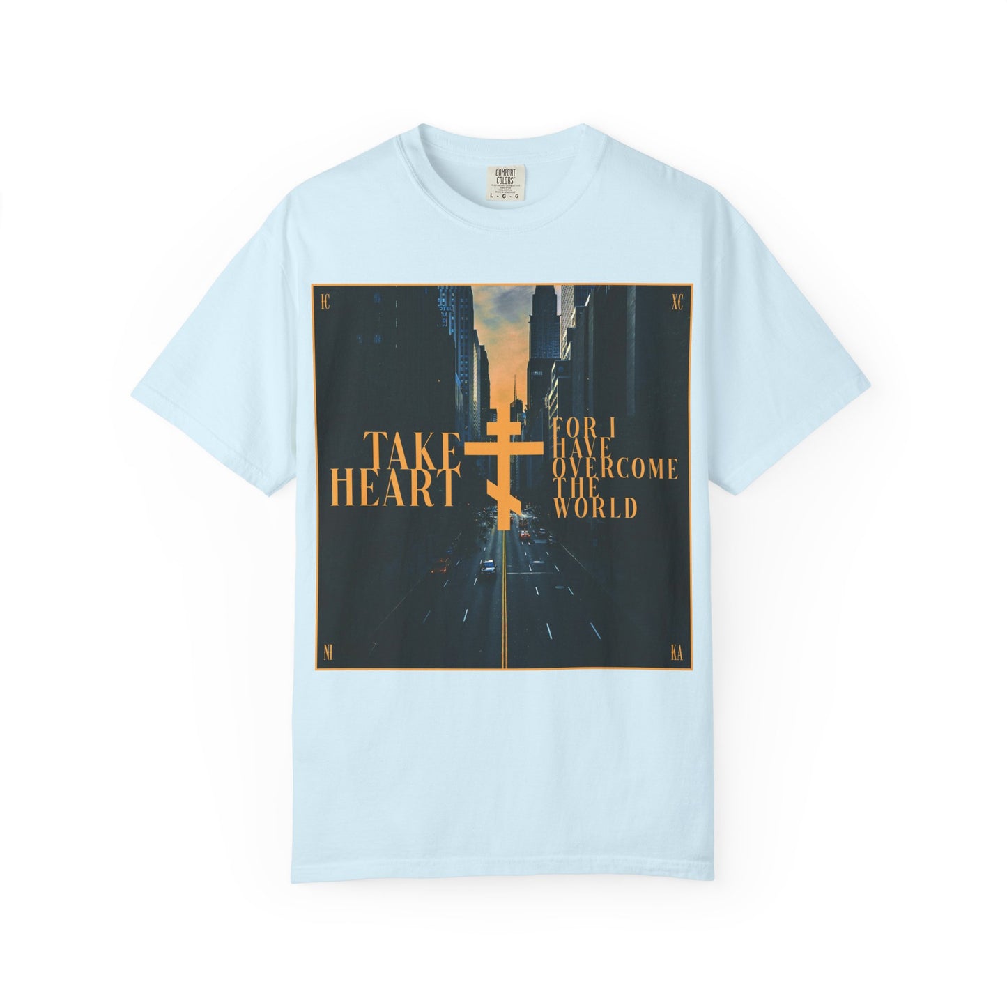 Chambray heavyweight cotton unisex tee featuring a modern city street scene and gold script reading, "Take Heart, For I Have Overcome the World (John 16:33)"—a reminder that sorrow can turn to joy when you ask and receive.