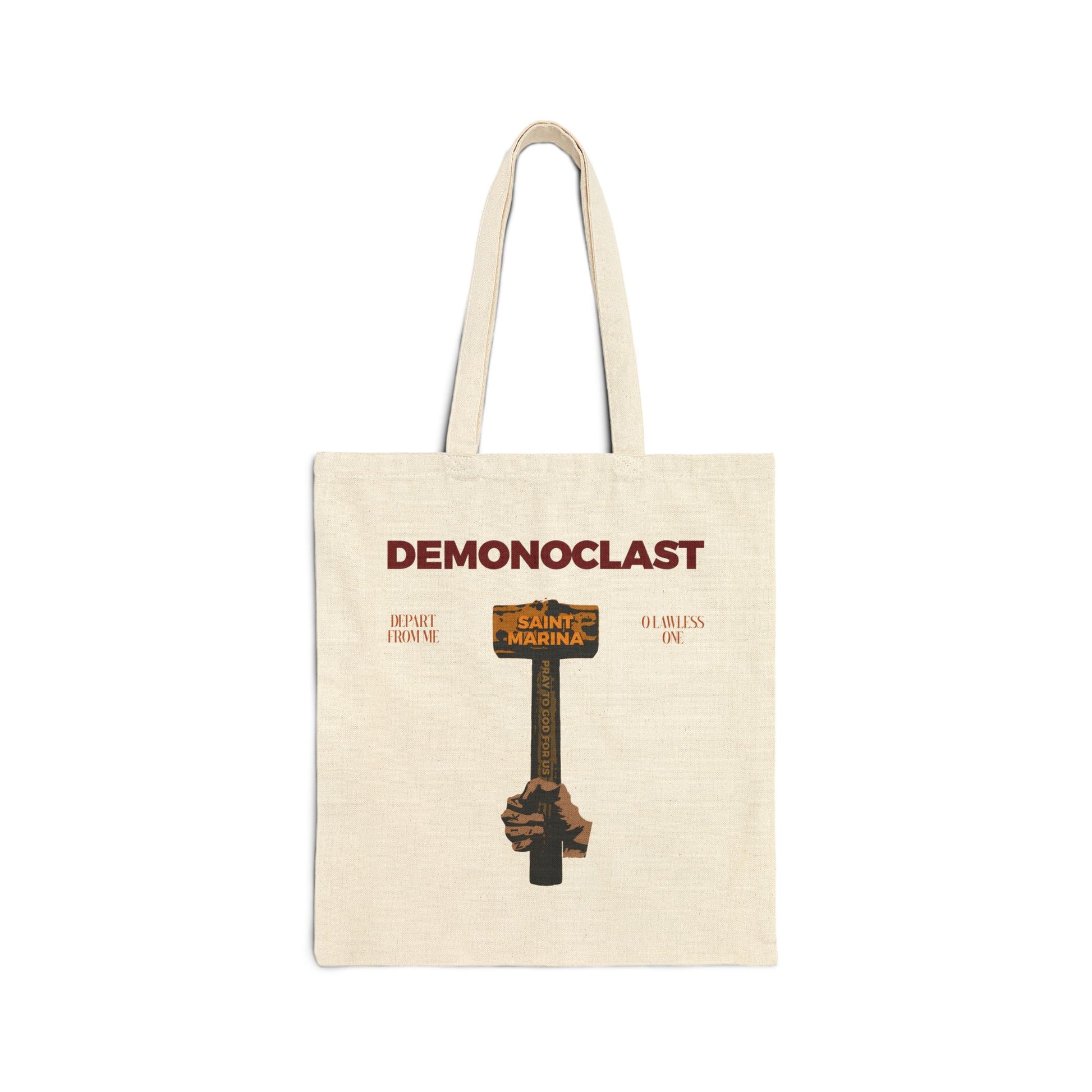 Natural tote bag featuring DEMONOCLAST and art of St. Marina’s hammer and NIKA fist, inspired by the Life of Saint Marina. Highlights themes of “Christ Conquers,” demon smashing, unseen warfare, Christian martyrdom, and Orthodox faith.