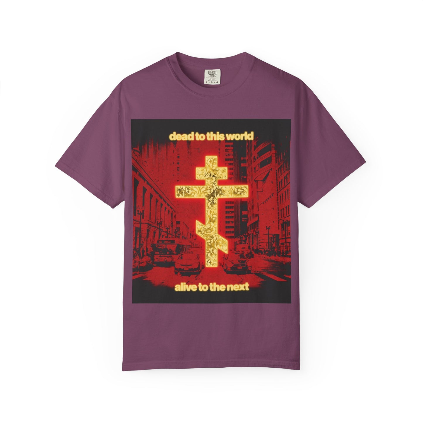 Berry-colored heavyweight cotton unisex tee featuring a glowing gold cross, red cityscape, and the phrase “Dead to This World, Alive to the Next”—a bold Orthodox Christian design inspired by reflections on death and eternity.