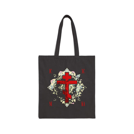 Black Orthodox Christian tote bag featuring a textured red ICXC NIKA cross with a medieval floral background—symbolizing “Jesus Christ Conquers” and spiritual triumph.