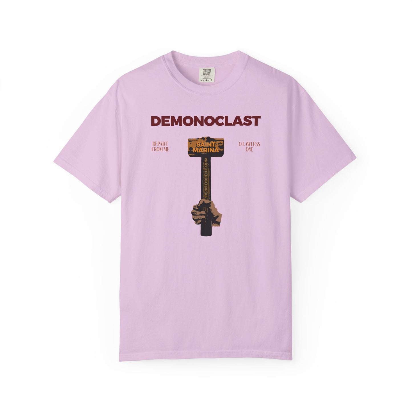 Orchid heavyweight cotton unisex tee with "DEMONOCLAST" text and a St. Marina-inspired NIKA fist graphic, symbolizing Christ's victory and unseen warfare.