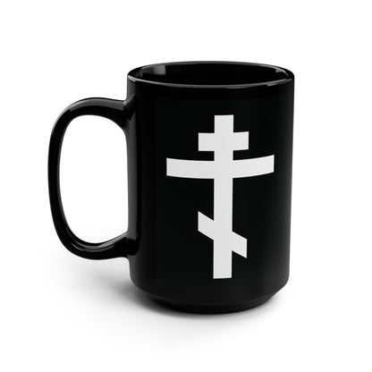 Black mug featuring a white Orthodox cross and the quote "May I never boast, except in the cross of our Lord Jesus Christ" (Gal 6:14), inspired by St. John of Kronstadt. Photographed on a white background.