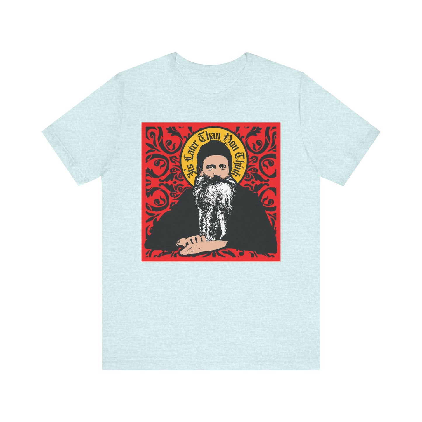 Heather Prism Ice Blue unisex tee with Saint Seraphim Rose in icono-graphic style and the words "It's Later Than You Think" on a red ornate background—a lightweight cotton shirt for Orthodox Christians.