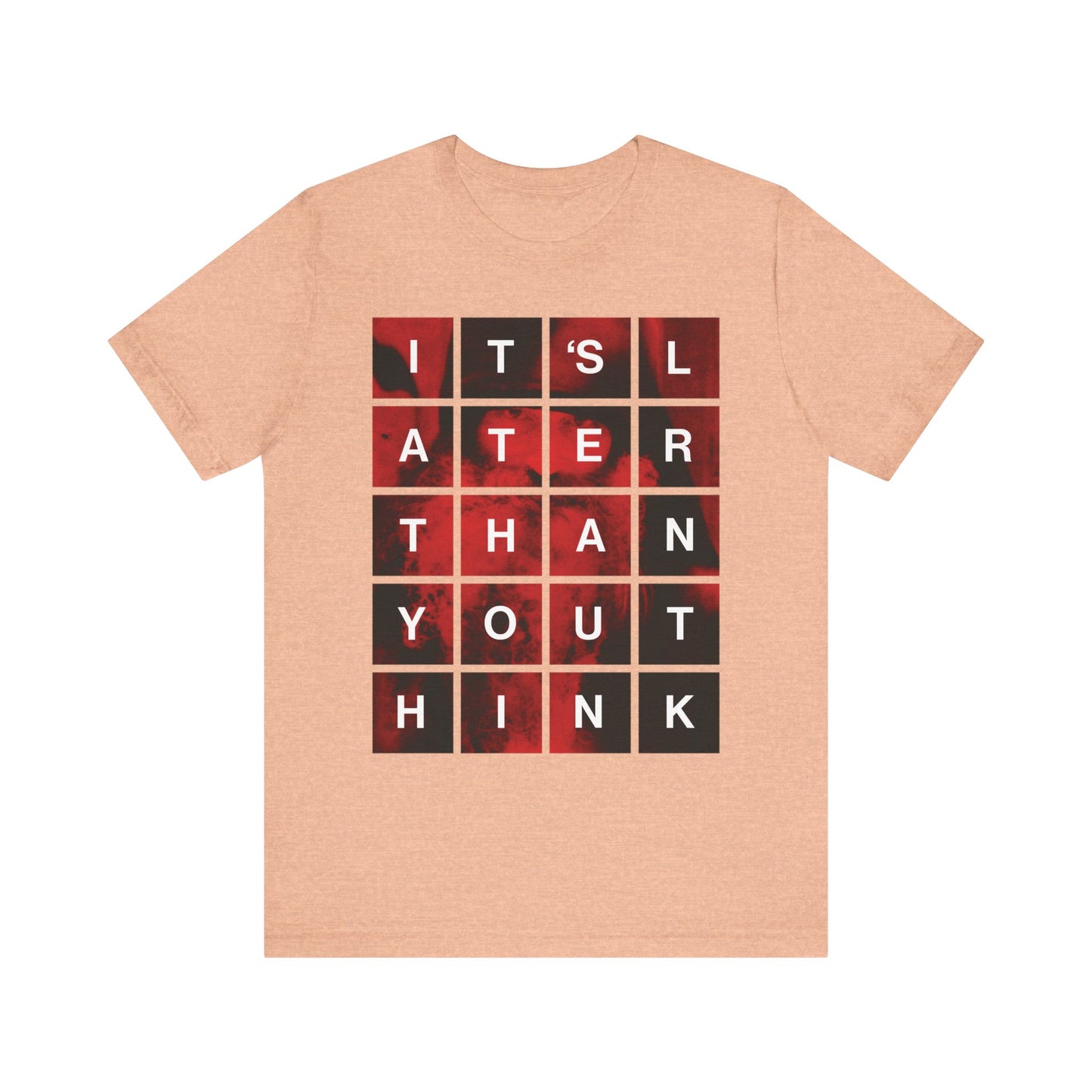 Heather peach t-shirt featuring a modern block grid design that reads "It's Later Than You Think" over a red and black background—a meaningful reminder of repentance and the urgency of seeking salvation, inspired by St. Seraphim Rose.