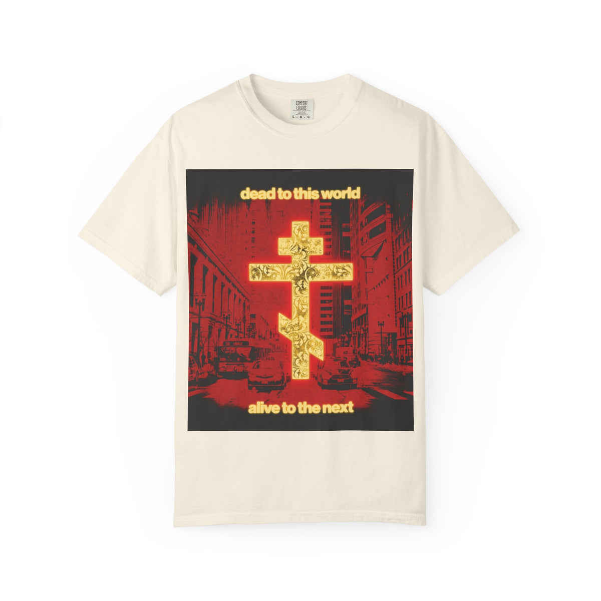 Ivory heavyweight cotton unisex tee featuring a glowing gold cross over a bold red cityscape; the text “Dead to This World, Alive to the Next” highlights Orthodox Christian themes of destiny and eternity.