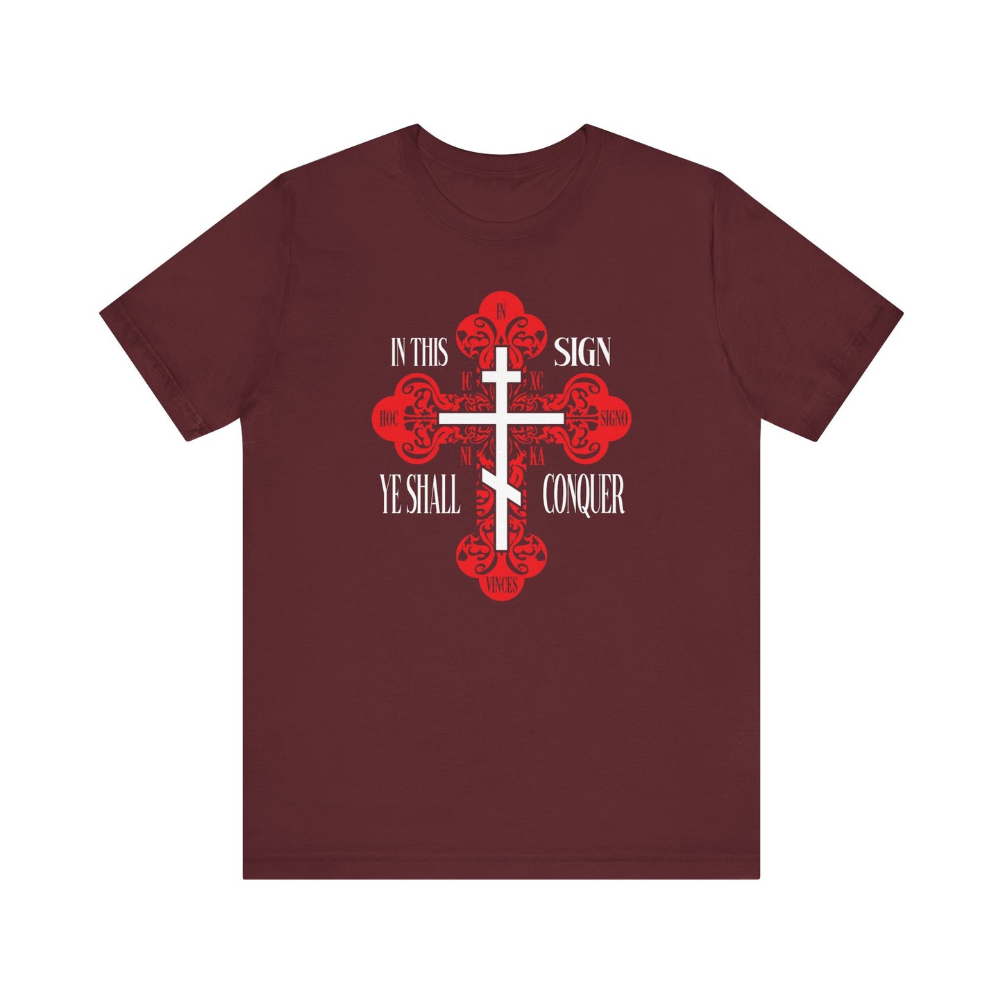Maroon lightweight cotton tee featuring a white ornate Orthodox cross with red accents and the text "In This Sign Ye Shall Conquer" (In Hoc Signo Vinces, ICXC NIKA, Christ Conquers). Unisex fit.