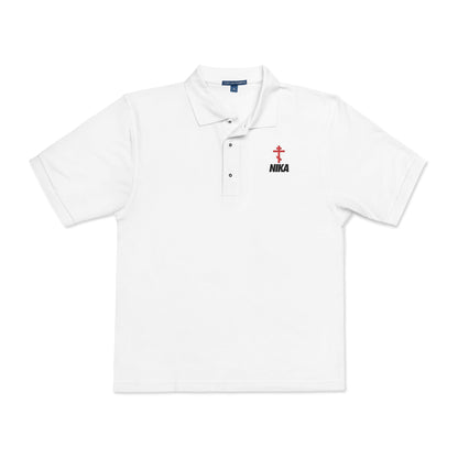 White polo shirt with an embroidered red Orthodox cross, black "NIKA" text on the left chest, inspired by the NIKE logo—symbolizing victory in Christ, as referenced in Revelation 3:21.