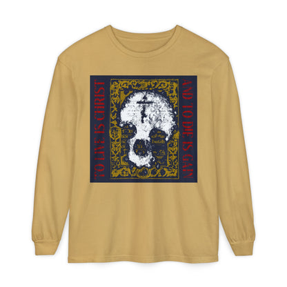 Mustard long sleeve shirt featuring a skull with cross on gold manuscript texture and the text “To Live is Christ, to Die is Gain” (Philippians 1:21). Orthodox Christian design expressing faith and new life in Christ.
