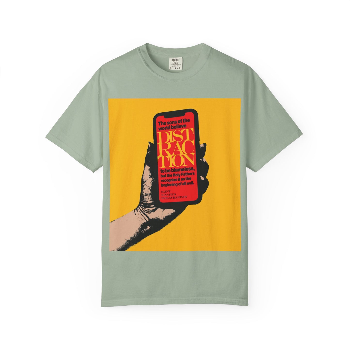 A heavyweight cotton unisex tee in Bay, featuring a graphic of a hand holding a phone and bold text about distraction—drawing inspiration from St Ignatius Brianchaninov and the teachings found in The Field—titled “Distraction is the Beginning of All Evil (St Ignatius Brianchaninov) | Mobile Phone Addiction | Orthodox Christian Tee.”.
