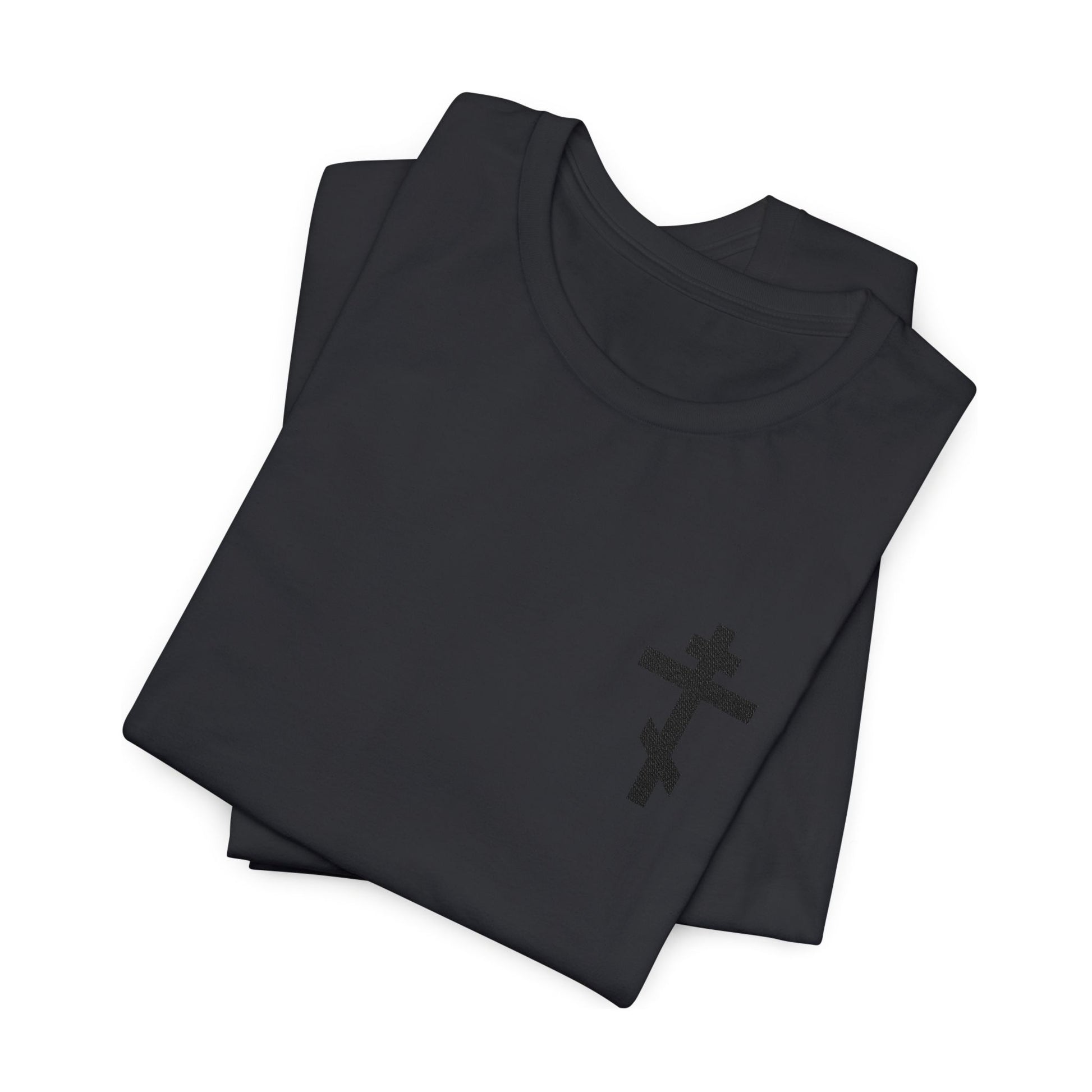 Two folded black cotton unisex t-shirts featuring a subtle black embroidered Orthodox cross, inspired by Galatians 6:14: "May I Never Boast Except in the Cross of Christ.