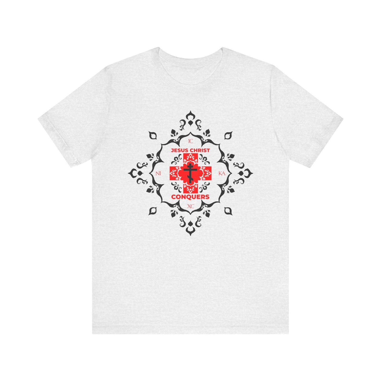 Ash t-shirt featuring the ICXC NIKA Orthodox Cross in red modern font with "Jesus Christ Conquers" text, highlighted by medieval filigree black decorative patterns. Lightweight unisex cotton tee inspired by the teachings of St. John Chrysostom.