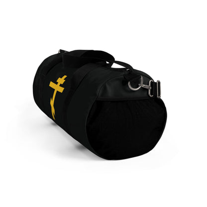 Black duffel bag featuring a yellow Orthodox cross on a black background with the phrase "Precious and Life-Giving Weapon of Unseen Warfare"—an Orthodox Christian gym bag displayed against a white backdrop.
