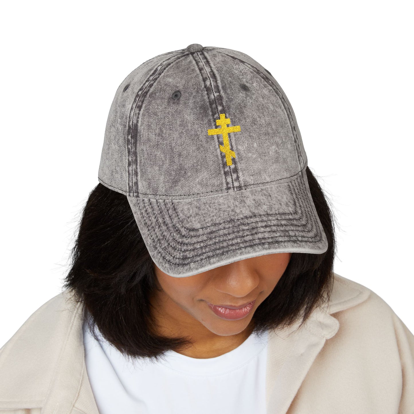 A woman wearing the Simple Yellow Orthodox TriBar Cross minimalist Christian distressed cap, featuring a yellow cross emblem, reflects on the message: "Crucify My Ego to the Precious and Life Giving Cross.