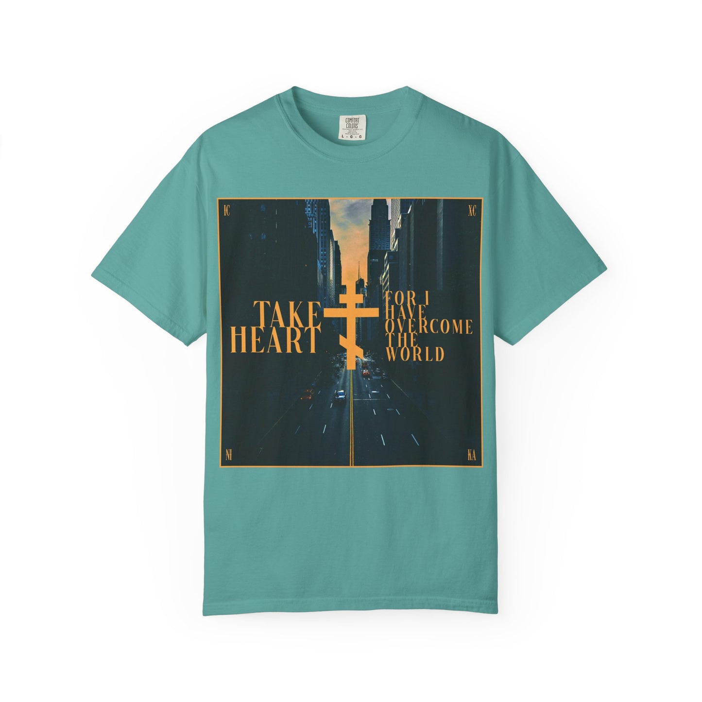 Seafoam "Take Heart, For I Have Overcome the World (John 16:33)" heavyweight cotton unisex tee featuring a modern city street scene, yellow cross, and inspiring message—a reminder that sorrow is turned into joy for those who believe.
