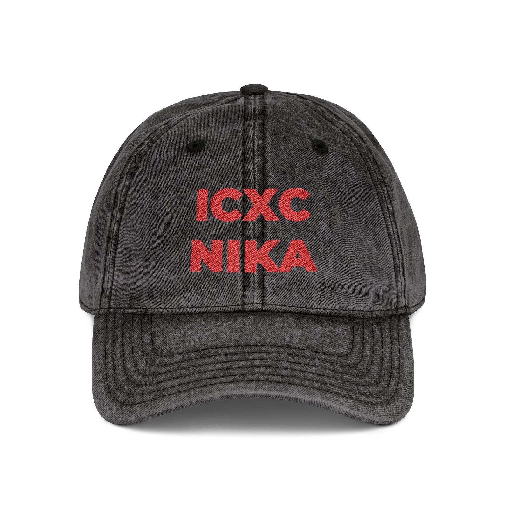 The Black Distressed Denim Cap features the red embroidered ICXC NIKA Christogram—an Orthodox Christian symbol meaning "Jesus Christ Conquers"—on the front.