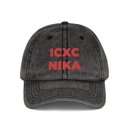 The Black Distressed Denim Cap features the red embroidered ICXC NIKA Christogram—an Orthodox Christian symbol meaning "Jesus Christ Conquers"—on the front.