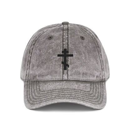 Charcoal grey distressed cap featuring a minimalist black Orthodox TriBar Cross, inspired by Christian faith. "Crucify My Ego to the Precious and Life Giving Cross" embroidered on front.
