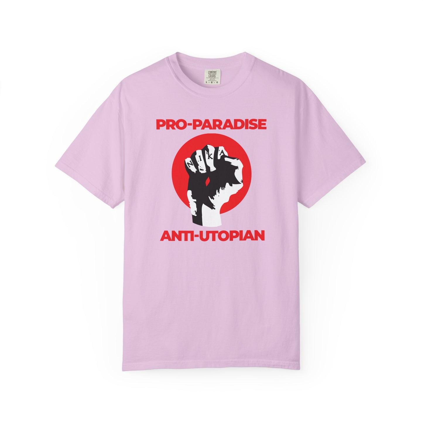 Orchid heavyweight cotton tee features a black NIKA fist, red circle, and "PRO-PARADISE ANTI-UTOPIAN" text—a bold take on resisting the dominant secular paradigm, inspired by the teachings of Jesus Christ Crucified.