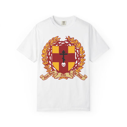 White heavyweight cotton unisex t-shirt featuring a heraldic shield with an Orthodox cross stabbing a skull, adorned with a crown of thorns and the “First-Born from the Dead (Col 1:18)” banner—an emblem inspired by redemption through His blood and themes from Colossians and Exodus.