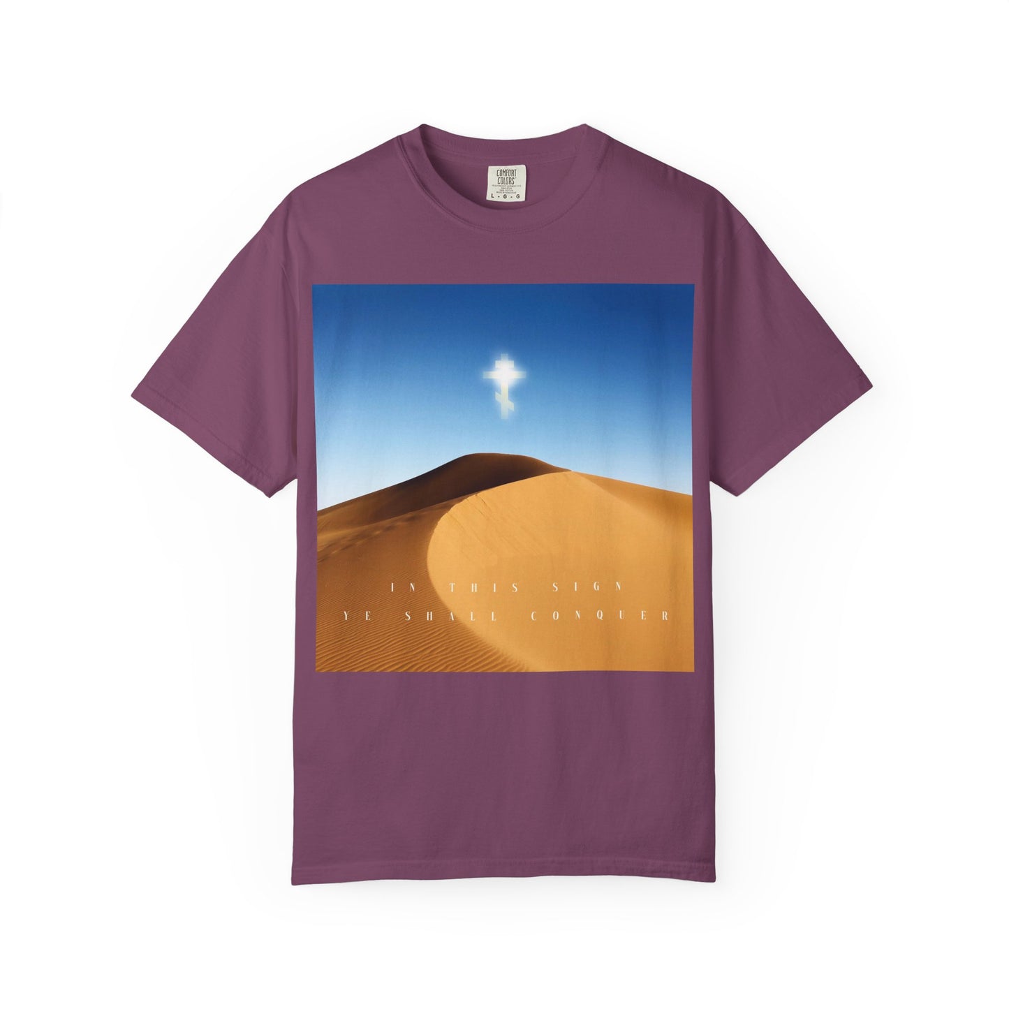Berry-colored heavyweight cotton unisex tee featuring a captivating desert sun scene with the Cross as the might of kings, and white text reading "IN THIS SIGN YE SHALL CONQUER.