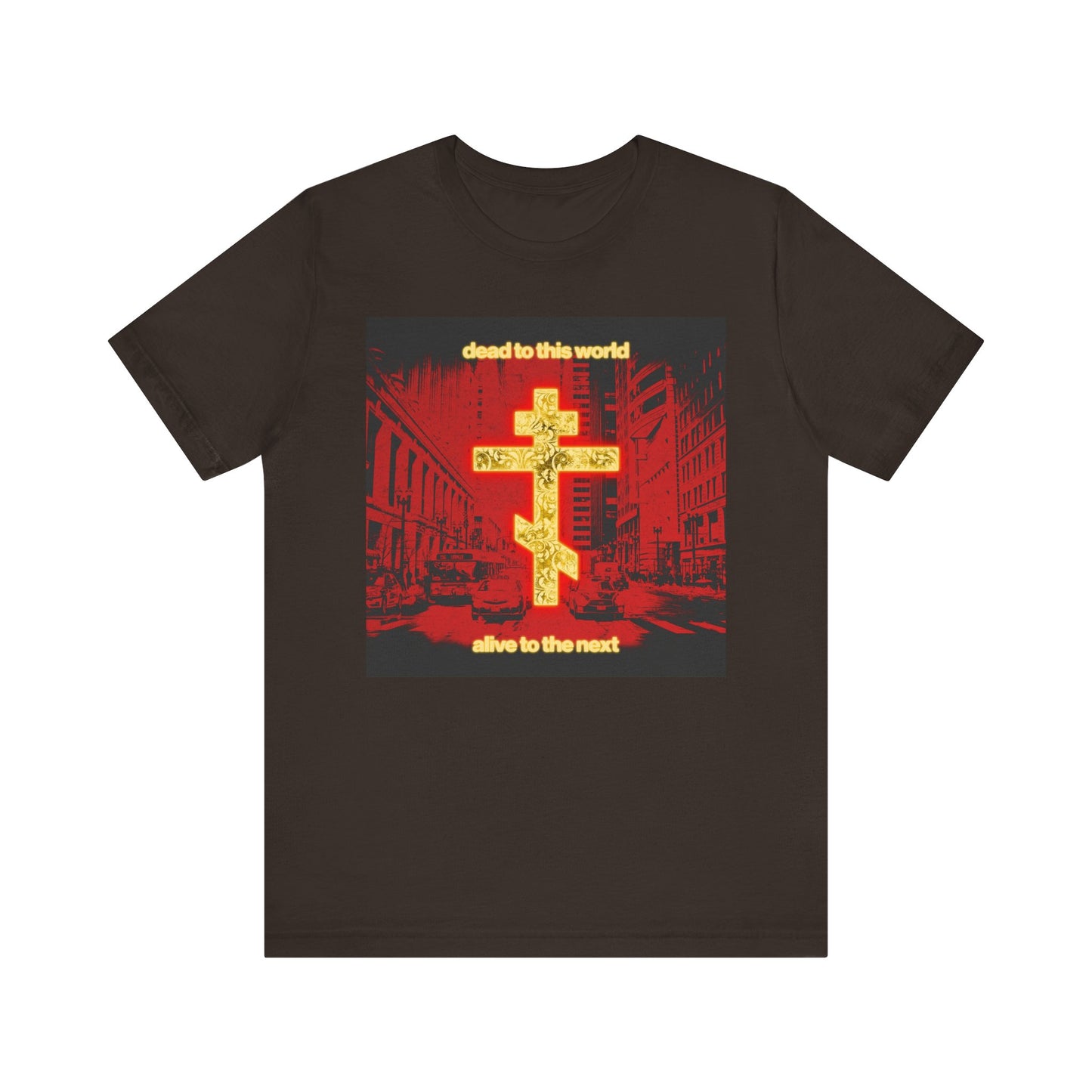 Brown "Dead to This World Alive to the Next" Orthodox Christian tee features a glowing gold cross over a red cityscape, inspired by St Ignatius Brianchaninov. Lightweight unisex cotton shirt with message on death and eternity.