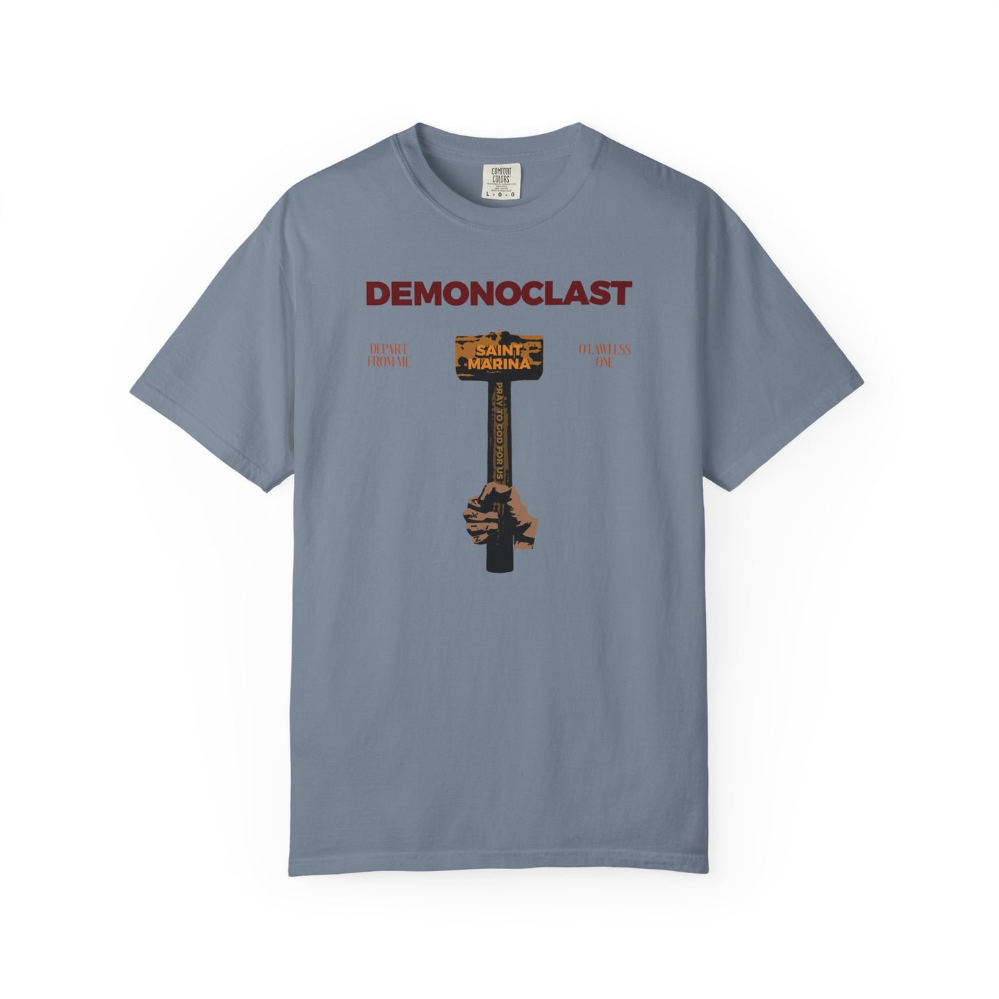 Blue Jean unisex tee featuring "DEMONOCLAST" and St. Marina’s hammer, symbolizing courage and martyrdom. Heavyweight cotton, Orthodox design with NIKA fist and Christ Conquers motif from the Unseen Warfare series.