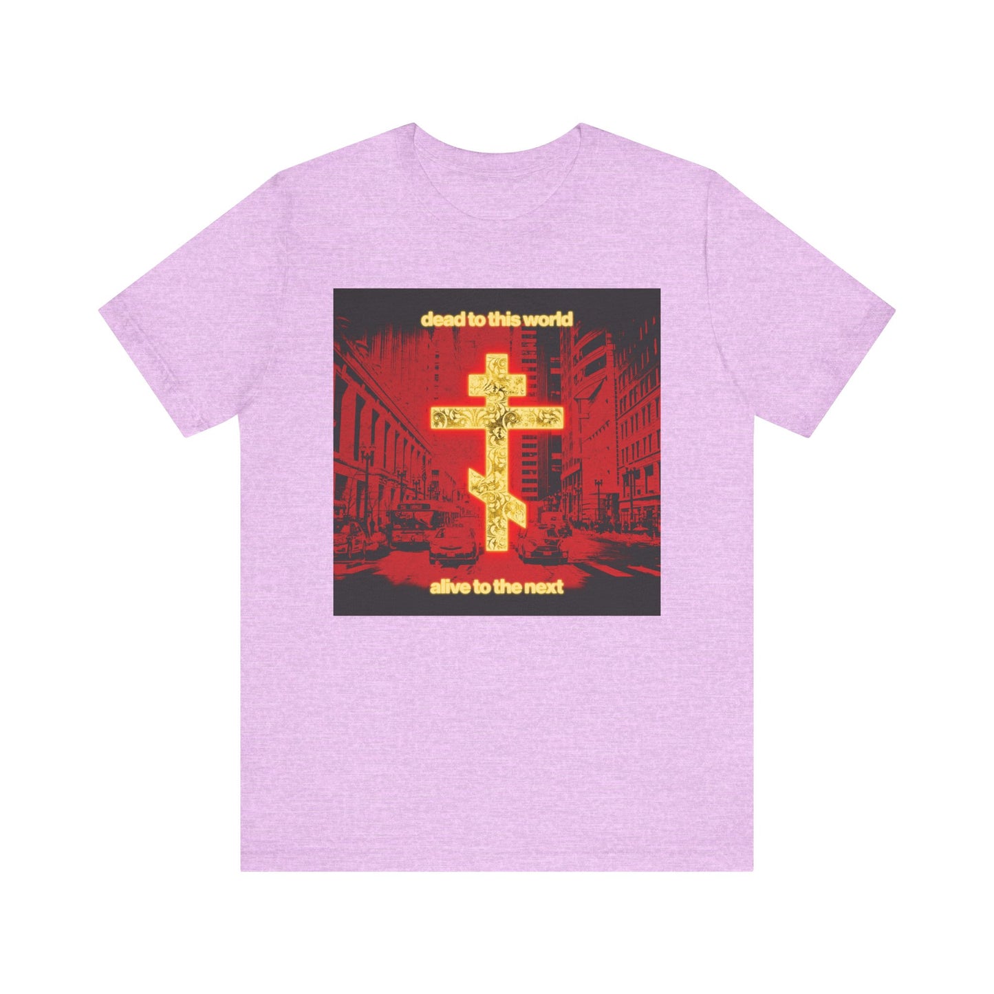 Heather Prism Lilac tee with a glowing gold cross and red cityscape, featuring "Dead to This World Alive to the Next"—an Orthodox Christian message inspired by St Ignatius Brianchaninov. Lightweight cotton unisex fit.