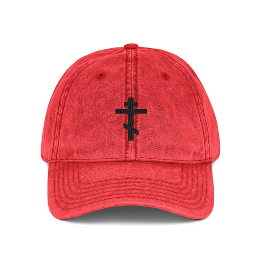 Red minimalist distressed cap, featuring a simple black Orthodox TriBar Cross embroidered on the front, inspired by "Crucify My Ego to the Precious and Life Giving Cross.