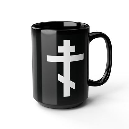 A black mug with a white Orthodox cross and the inscription “May I never boast, except in the cross of our Lord Jesus Christ” (Gal 6:14), inspired by St. John of Kronstadt and the Saviour’s sacrifice.