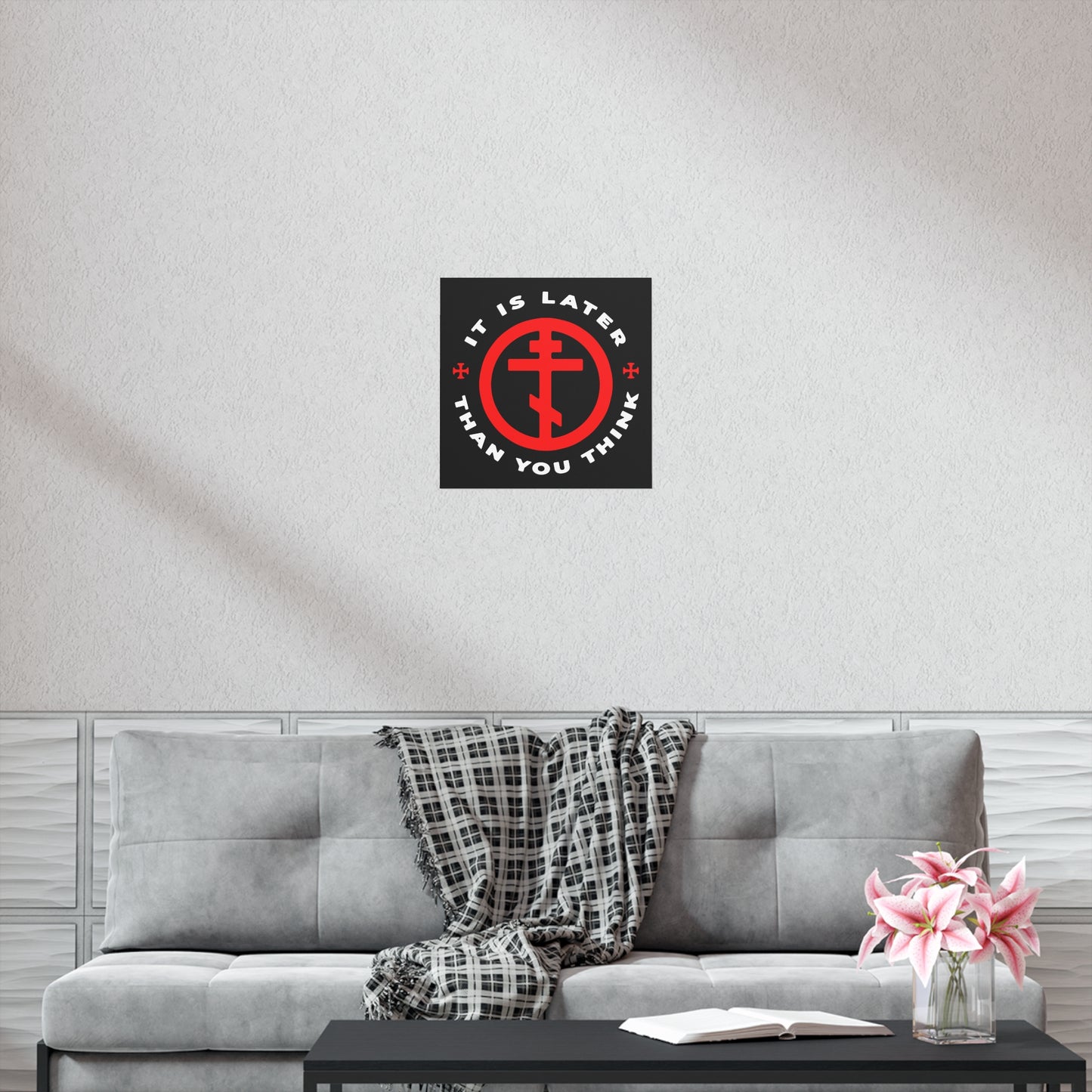 Modern living room with a gray sofa, plaid throw, pink flowers, and an "It Is Later Than You Think | Fr Seraphim Rose | Christian Art Poster" featuring the Orthodox Cross in Circle—a memento mori echoing timeless wisdom.