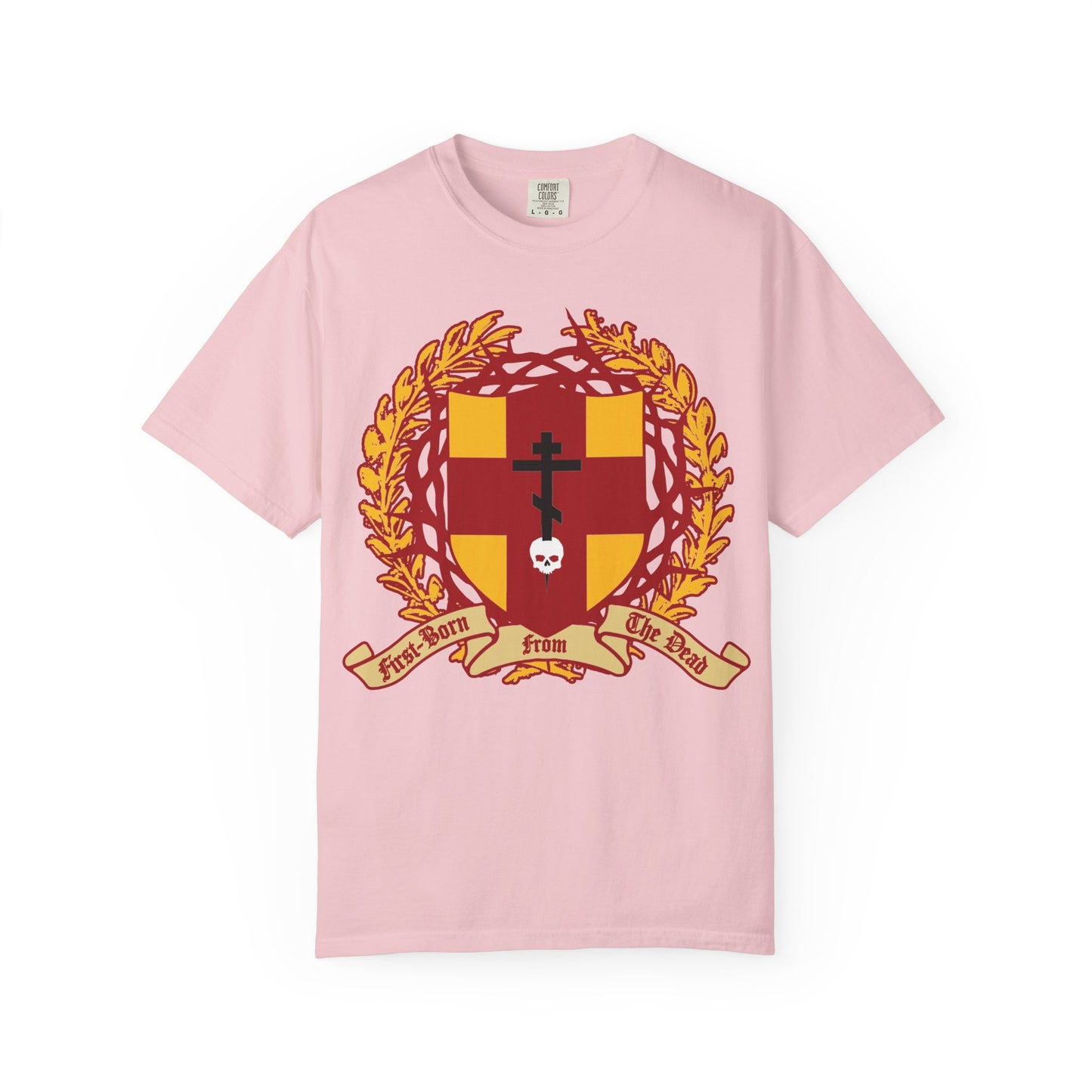 Blossom heavyweight cotton unisex t-shirt featuring a heraldic shield with an Orthodox cross stabbing a skull, crowned by thorns—alongside a laurel wreath and ribbon reading “First-Born from the Dead”—a striking design inspired by Colossians 1:18 and the promise of redemption through His blood.
