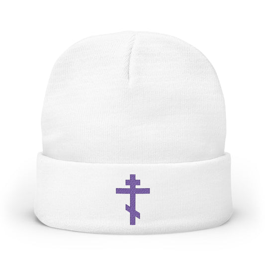 White beanie with an embroidered blue-purple Orthodox TriBar Cross on the front, inspired by the prayer "Nail My Passions to the Wood of Thy Precious Cross O Lord.
