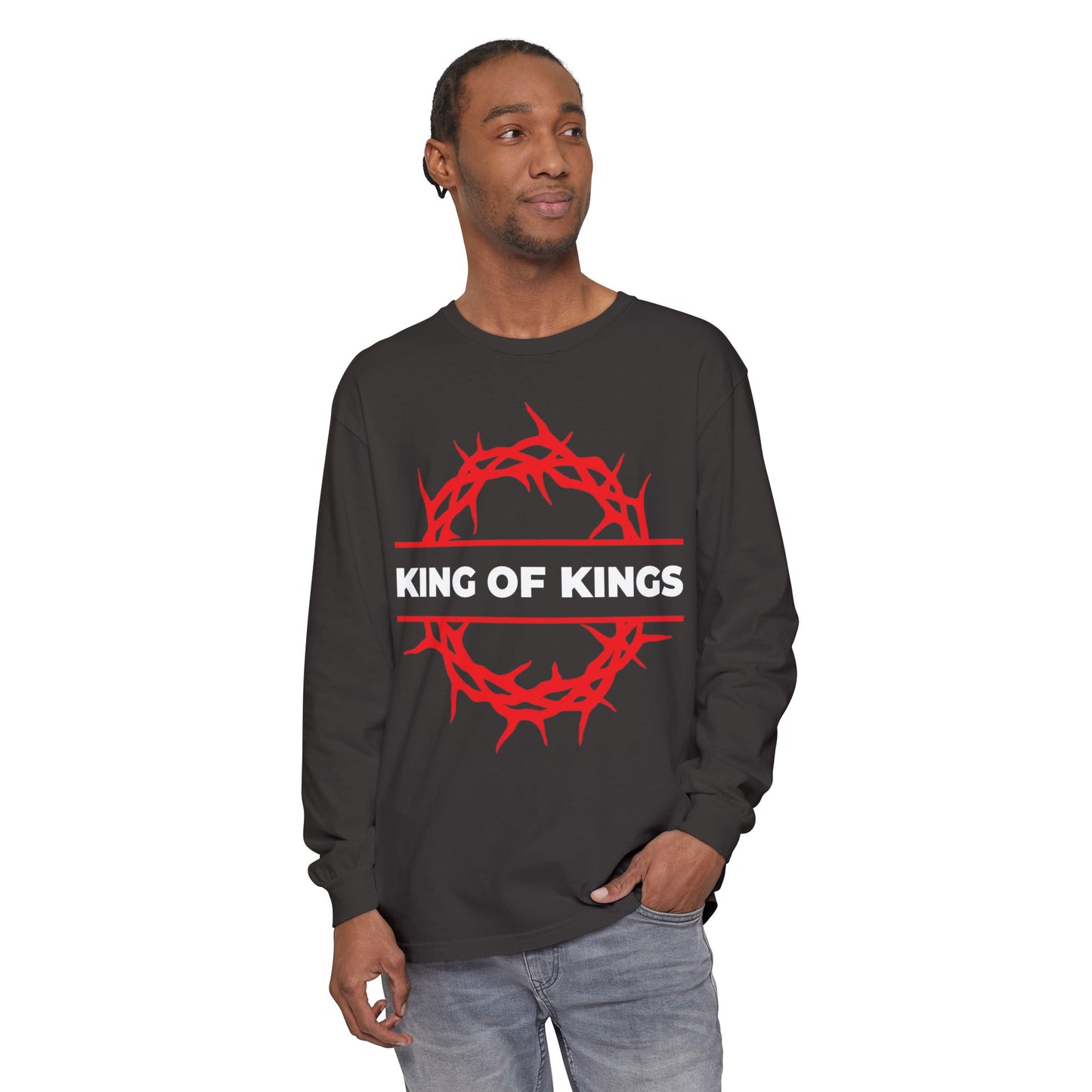Man wearing the "King of Kings Crown of Thorns | The King of Glory | Christ is King | Revelation 19:16" Christian cotton long sleeve shirt with a red crown of thorns graphic, standing and looking to the side.