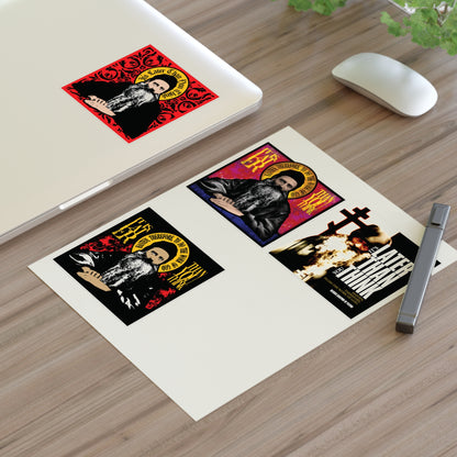 Laptop with red sticker, Fr Seraphim Rose Four Sticker Sheet No. 1 on paper, mouse, pen, and plant on desk.