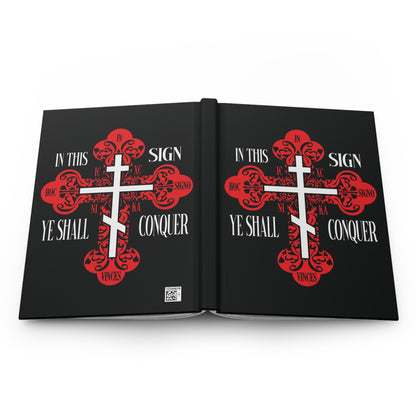 Black book cover featuring a red ornate Orthodox Cross and the text "In This Sign Ye Shall Conquer | In Hoc Signo Vinces | ICXC NIKA | Jesus Christ Conquers"—a Christian journal symbolizing victory through the life-giving Cross.