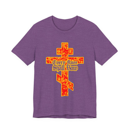 Purple unisex tee featuring a gold and red floral Orthodox cross with "Every Knee Shall Bow" in Gothic lettering, inspired by Isaiah 45:22-24 and Philippians 2:7-11. Christian message proclaiming Jesus Christ is Lord.