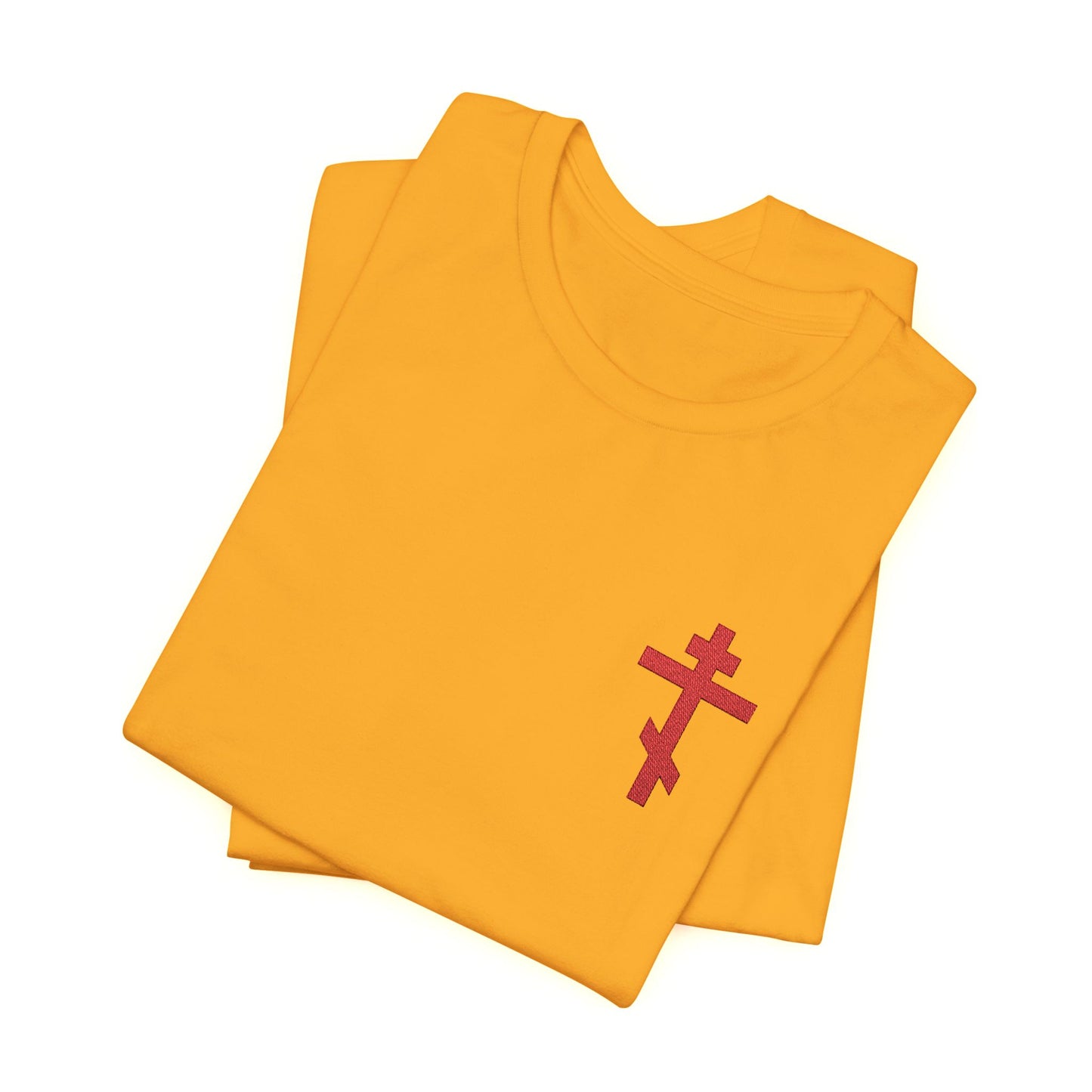 Folded yellow unisex cotton t-shirt featuring a small red embroidered Orthodox cross and inspired by Galatians 6:14—“May I Never Boast Except in the Cross.”.