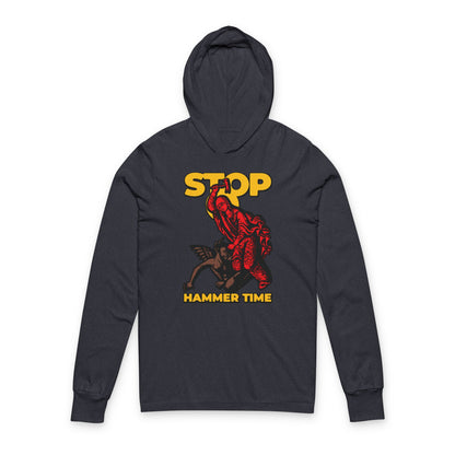 Black hoodie with a red figure and yellow "STOP HAMMER TIME" text, inspired by St Marina of Antioch beating the devil with a hammer. Modern Orthodox meme design in red, blue, and yellow. Christian hooded shirt.