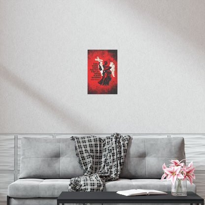 A gray couch with a plaid blanket, a book, and pink flowers sits beneath the "Little Divides Angels from Men | Christian Perfection | St John Chrysostom" Orthodox Christian Art Poster, creating a peaceful spot for reflection and grace.