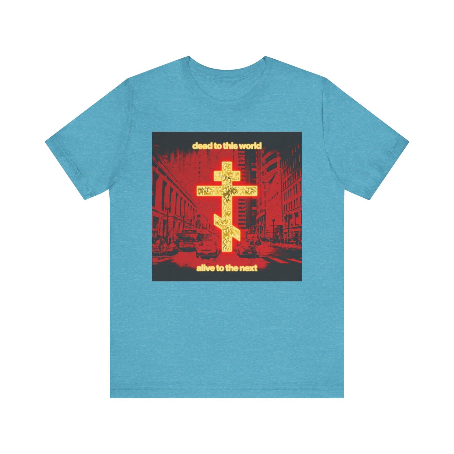 Heather Aqua unisex tee with a glowing gold cross over a red cityscape and the text "dead to this world, alive to the next," inspired by St. Ignatius Brianchaninov’s reflections on death and eternity. Lightweight cotton.