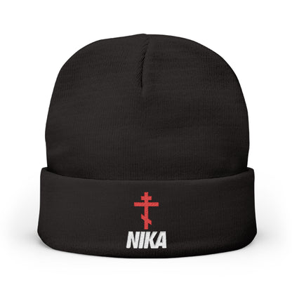 The NIKA Red Embroidered Orthodox Cross Knit Beanie is black, featuring an athletic Orthodox cross and white NIKA Christogram on the front—a unique NIKE logo mashup with Orthodox Christian iconography.